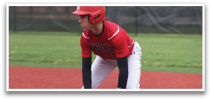 A baseball player in a red and white uniform is crouching on the field. Description generated by AI