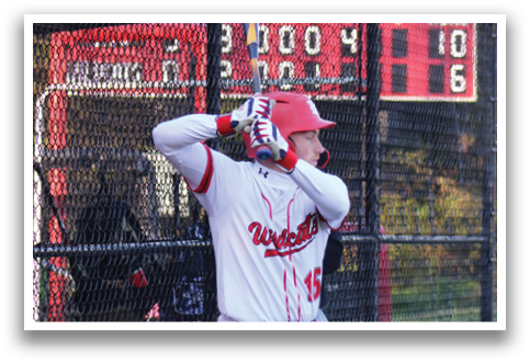 A baseball player is holding a bat and getting ready to hit a ball. Description generated by AI