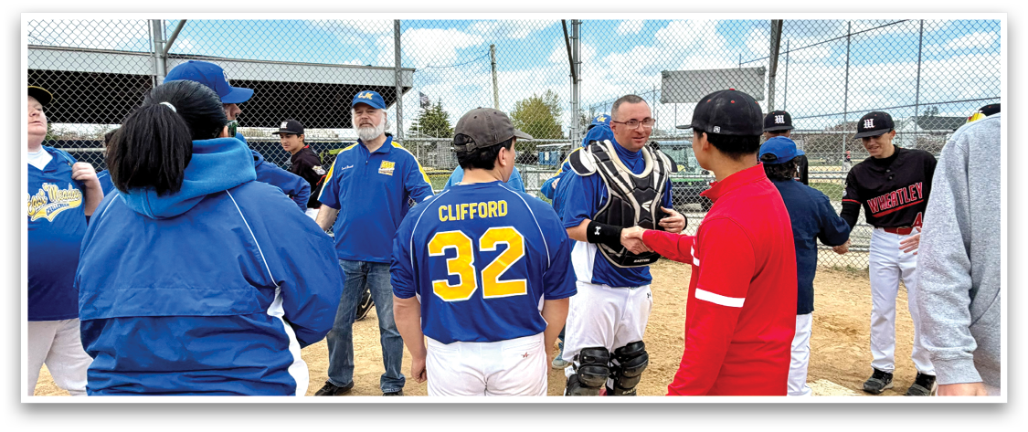 A group of people standing on a baseball field. Description generated by AI