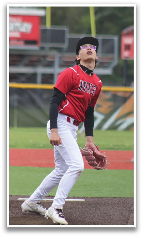 A baseball player in a red and white uniform is on the pitcher's mound. Description generated by AI
