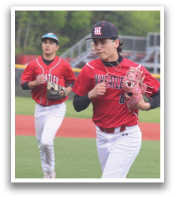 Two baseball players wearing red shirts and white pants. Description generated by AI