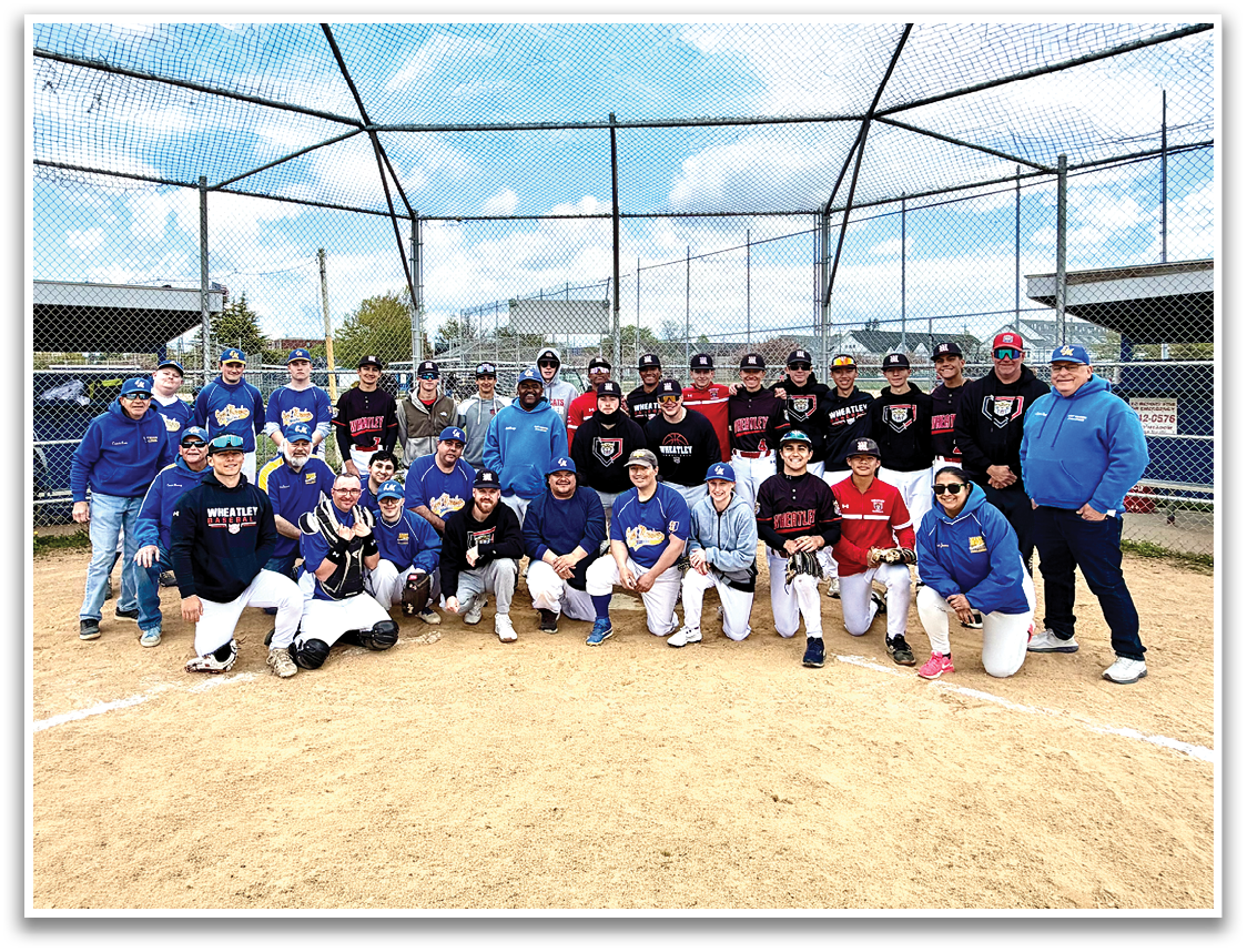 A group of people posing for a picture on a baseball field. Description generated by AI