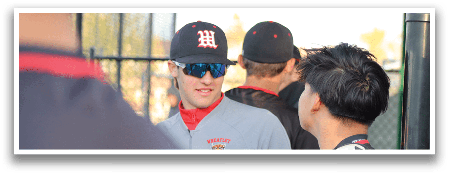 A group of people wearing baseball caps and jerseys. Description generated by AI