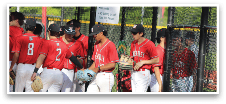 A group of baseball players wearing red and white uniforms. Description generated by AI