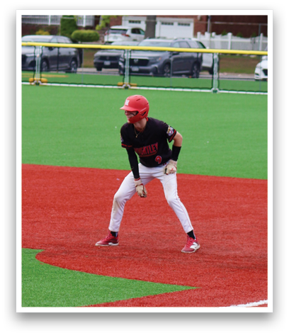 A baseball player in a red helmet and white uniform is running to first base. Description generated by AI