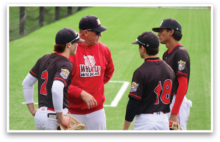 Three baseball players wearing black and red uniforms. Description generated by AI