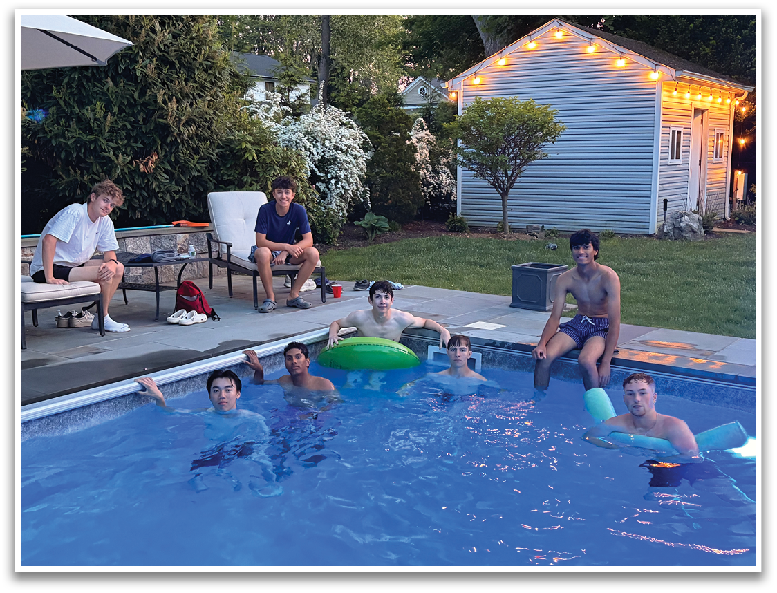 A group of people are sitting in a pool. Description generated by AI