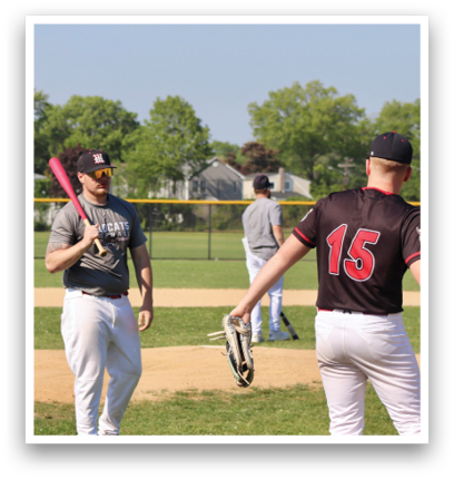 A baseball player holding a bat. Description generated by AI