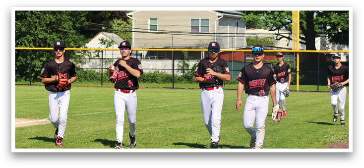 A group of baseball players walking on a field. Description generated by AI