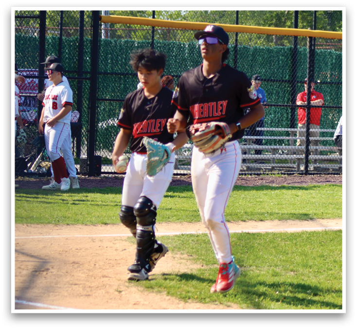 Two baseball players walking on the field. Description generated by AI