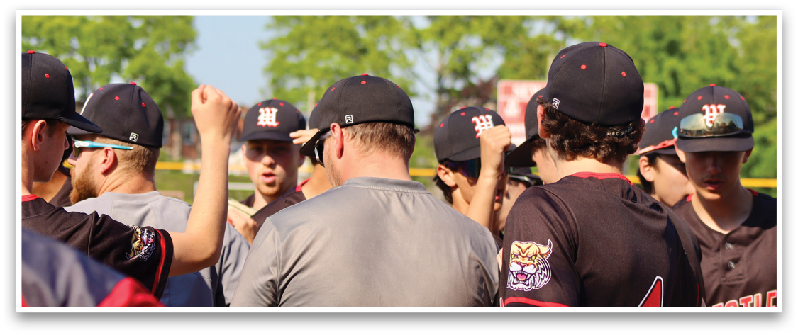 A group of people wearing baseball caps and jerseys. Description generated by AI