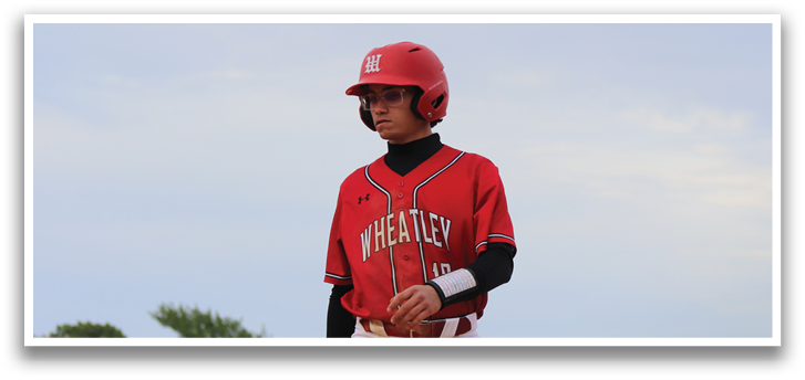 A boy wearing a red and white baseball uniform. Description generated by AI