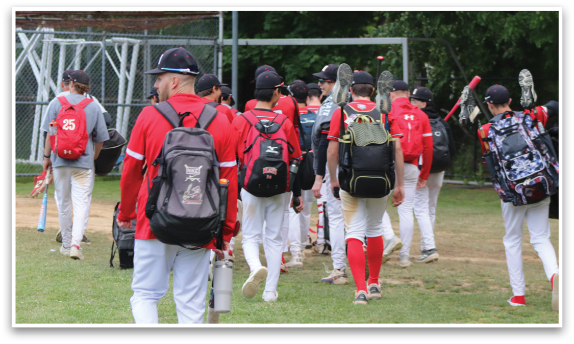 A group of baseball players walking on a field. Description generated by AI