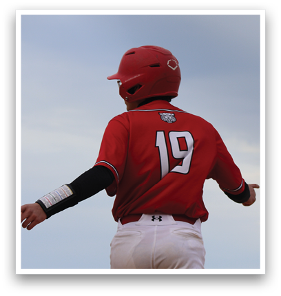 A boy wearing a red shirt and white pants. Description generated by AI