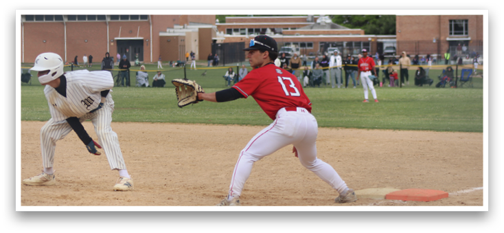 A baseball player in a red shirt is running to a base. Description generated by AI