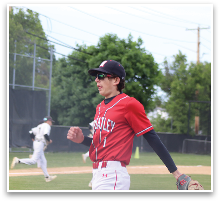 A baseball player wearing a red shirt and white pants. Description generated by AI