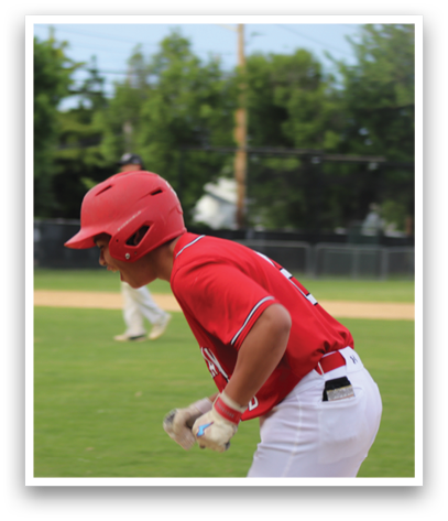 A baseball player wearing a red shirt and white pants. Description generated by AI