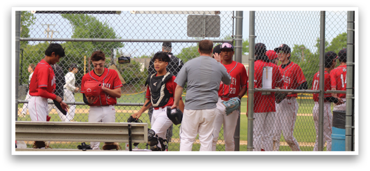 A group of baseball players standing on a field. Description generated by AI