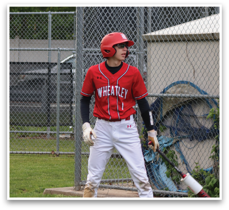A boy wearing a red shirt and a red helmet. Description generated by AI