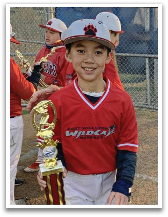 A young boy holding a trophy. Description generated by AI