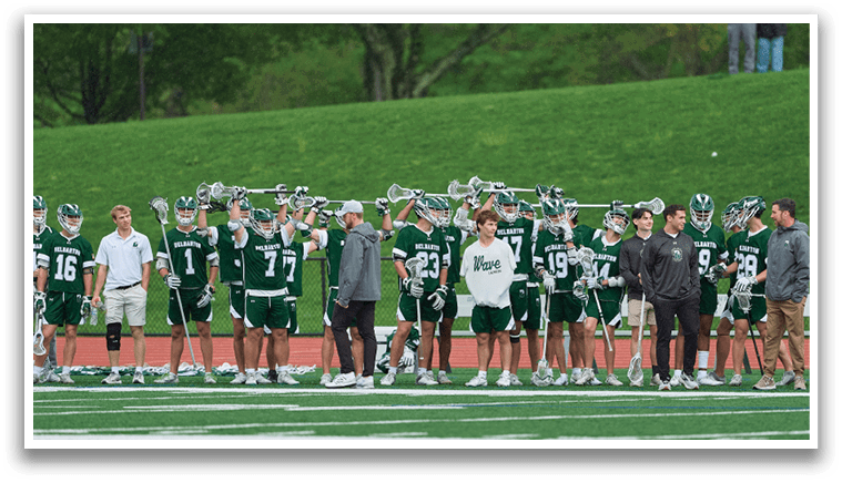 A group of people are standing on a field, holding lacrosse sticks. AI generated content