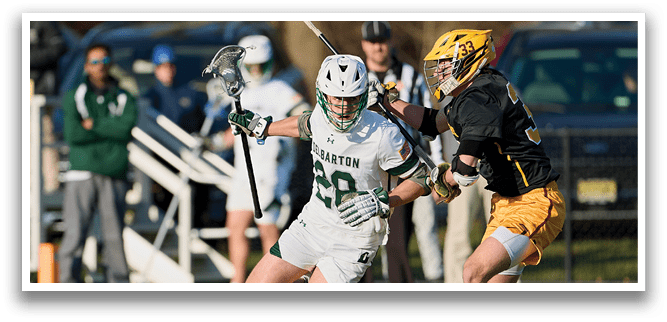 A lacrosse game is in progress with players on the field. A man in a white uniform is holding a lacrosse stick and running towards the goal. The goalie is trying to block the shot. AI generated content
