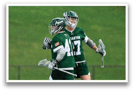 Two men wearing green and white uniforms are walking on a field. AI generated content
