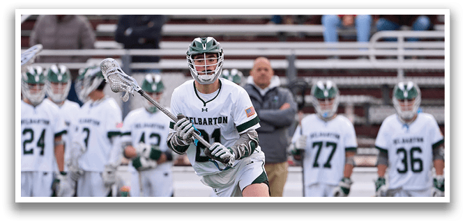 A lacrosse player in a green and white uniform is running with a stick in his hand. AI generated content