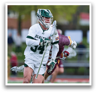 A man wearing a white shirt and green shorts is playing lacrosse. AI generated content