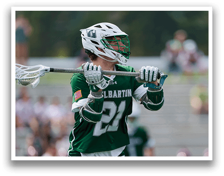 A man wearing a green and white uniform is holding a lacrosse stick. AI generated content