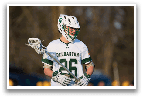 A man wearing a white and green jersey with the number 26 on it is holding a lacrosse stick. AI generated content
