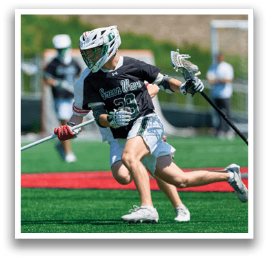 A man in a black and white uniform is running on a field with a lacrosse stick. AI generated content