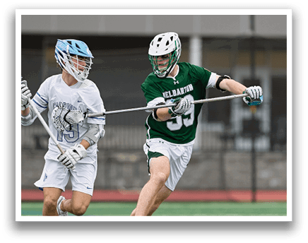 Two men playing lacrosse on a field. One man is running with a stick, while the other is wearing a helmet and catching a ball. AI generated content