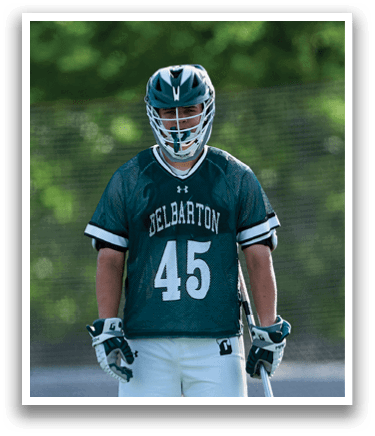 A man wearing a green jersey with the number 45 stands on a field holding a lacrosse stick. AI generated content