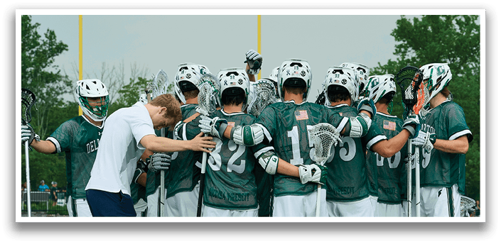Three young men are playing lacrosse on a field. One is wearing a green shirt and white shorts, another is wearing a white shirt and green shorts, and the third is wearing a white shirt and white shorts. They are all holding lacrosse sticks and running towards the ball. AI generated content
