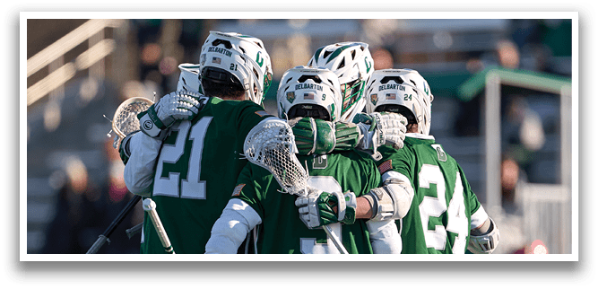A group of lacrosse players huddle together on the field. AI generated content