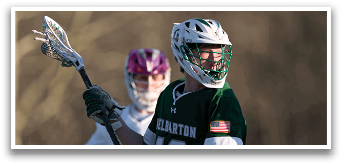 A man wearing a green and white uniform is holding a lacrosse stick. AI generated content