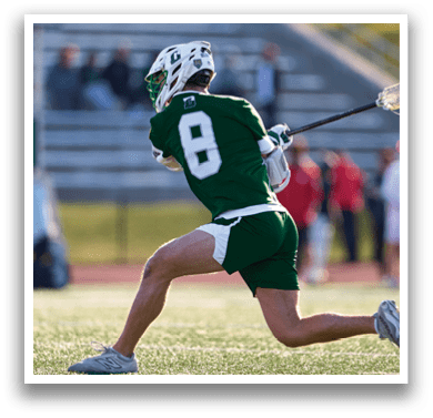 A man in a green and white uniform is running with a lacrosse stick in his hand. AI generated content