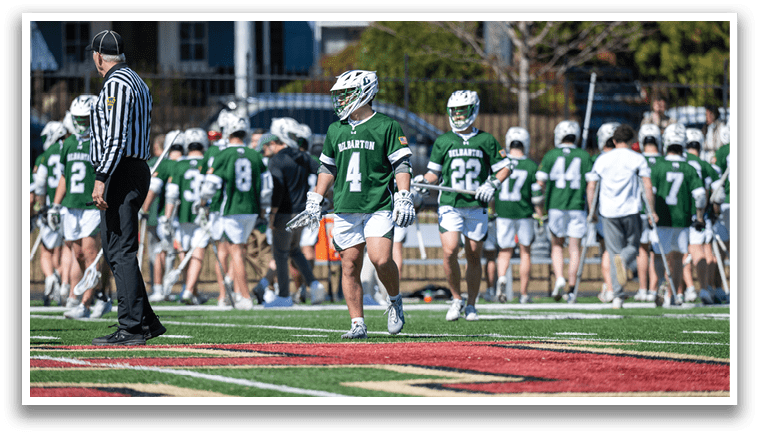 A group of people in green and white uniforms are playing a game of lacrosse. AI generated content