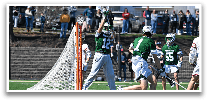 A group of people playing a game of lacrosse. A man in a green shirt is holding a lacrosse stick and getting ready to shoot the ball. AI generated content