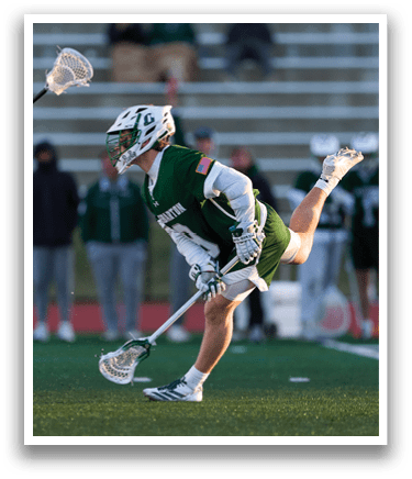 A lacrosse player in a green uniform is running with a stick in his hand. AI generated content