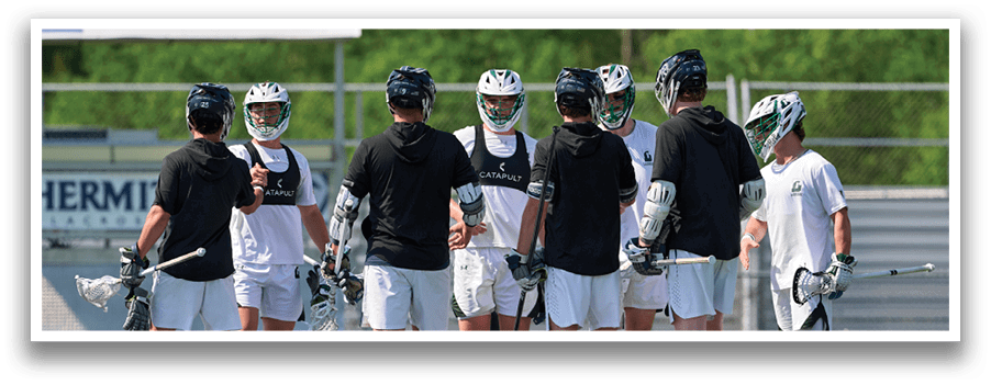 A group of men wearing black and white uniforms are standing on a field. Description generated by AI