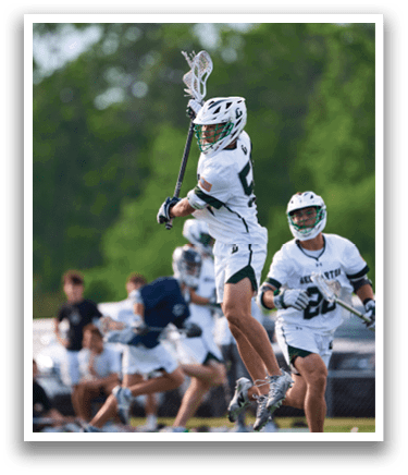 A man is jumping in the air with a lacrosse stick. Description generated by AI