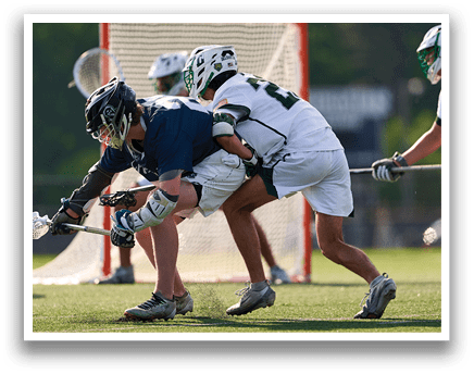 A group of men playing lacrosse on a field. Description generated by AI
