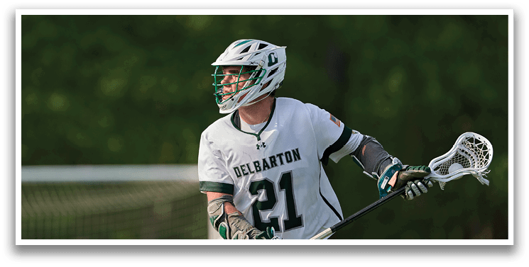 A man wearing a white and green jersey with the number 21 on it. Description generated by AI