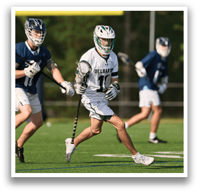 A man wearing a green and white uniform is running with a stick in his hand. Description generated by AI
