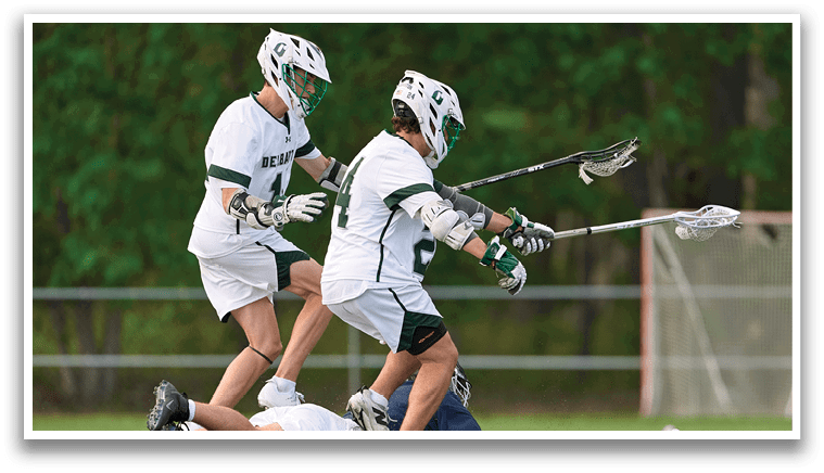 Two men playing lacrosse. Description generated by AI