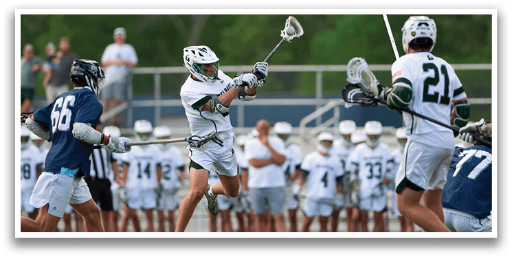A group of people playing a game of lacrosse. Description generated by AI