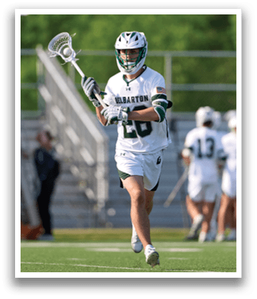 A man wearing a white jersey with the number 21 on it is running on a field. Description generated by AI