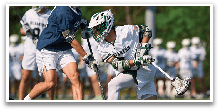 A man in a white uniform is running with a stick. Description generated by AI
